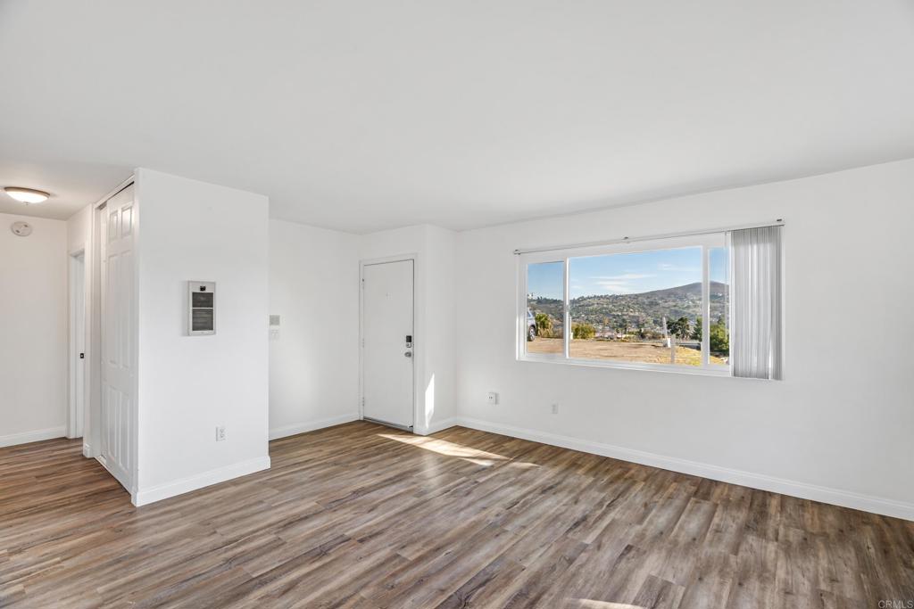 2964 Crane Street, Unit A B Lemon Grove, CA 91945 - Photo 5 of 50 a view of an empty room with wooden floor and a window