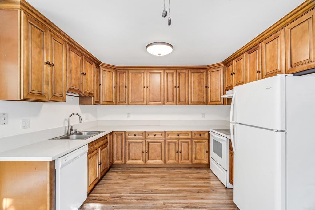 2964 Crane Street, Unit A B Lemon Grove, CA 91945 - Photo 6 of 50 a kitchen with a sink a refrigerator and cabinets