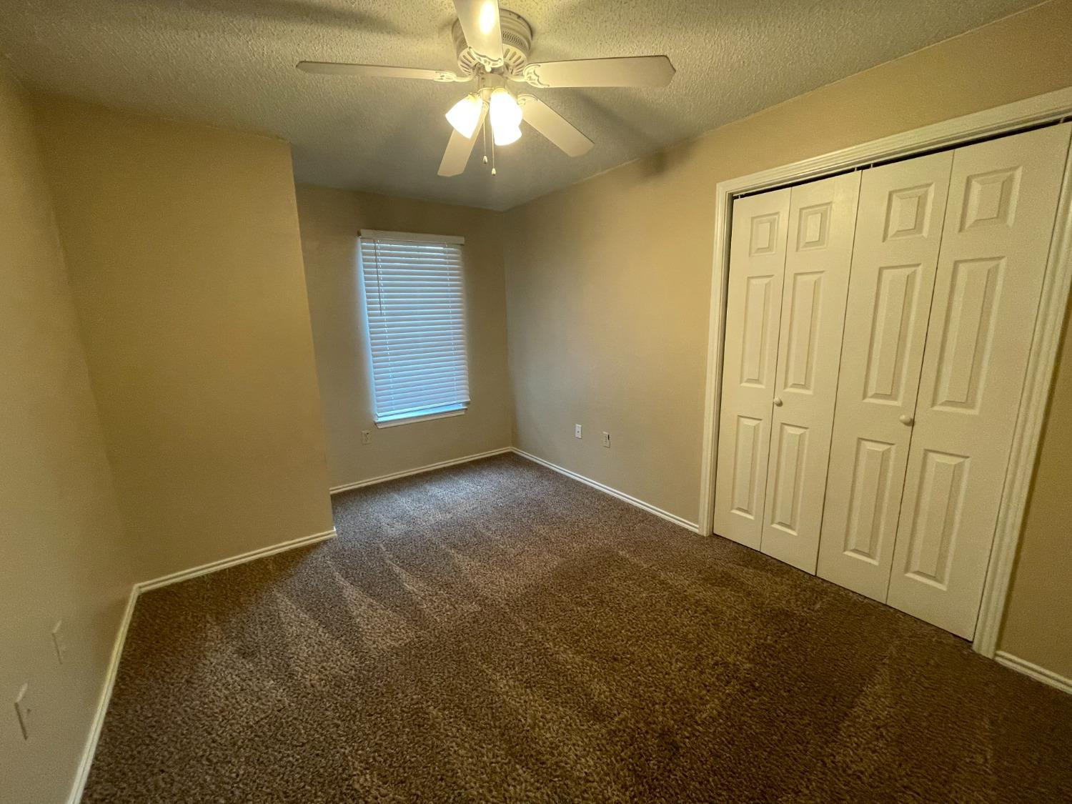 5827 6th Street, Unit A Lubbock, TX 79416 - Photo 5 of 10 a view of an empty room with a window
