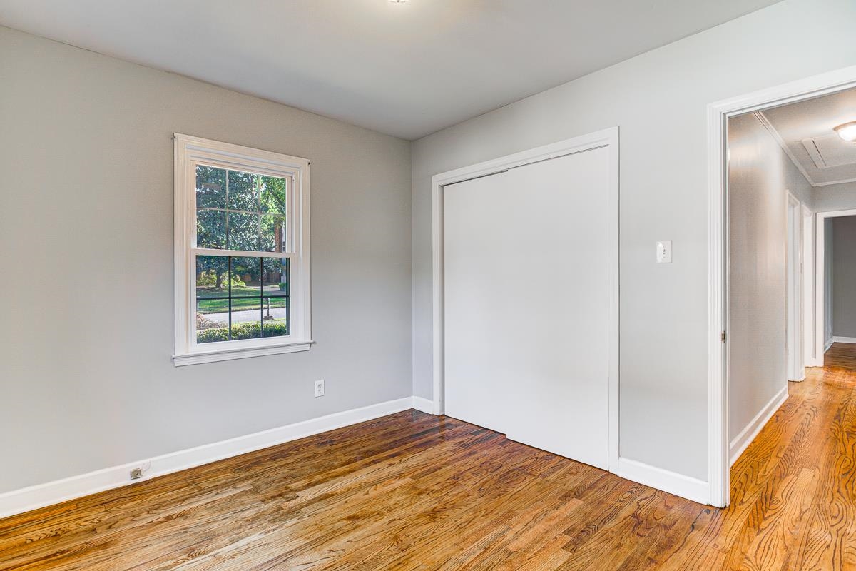 5676 Barfield Road Memphis, TN 38120 - Photo 14 of 19 Light gray painted walls with white trim and wood-finish flooring