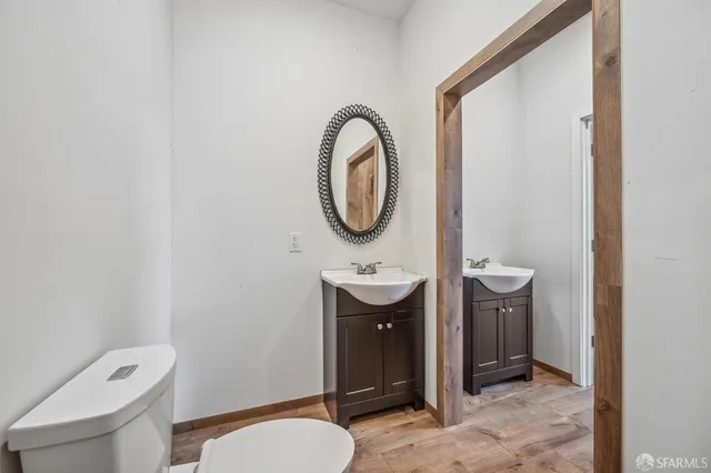 a bathroom with a toilet a sink and a mirror