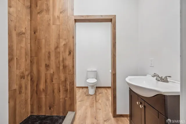 a bathroom with a sink a toilet and shower