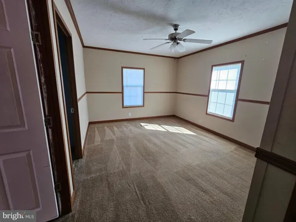 a view of a livingroom with a ceiling fan and window