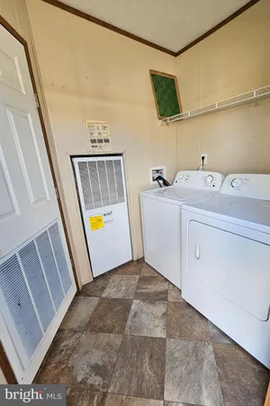 a view of a hallway with washer and dryer