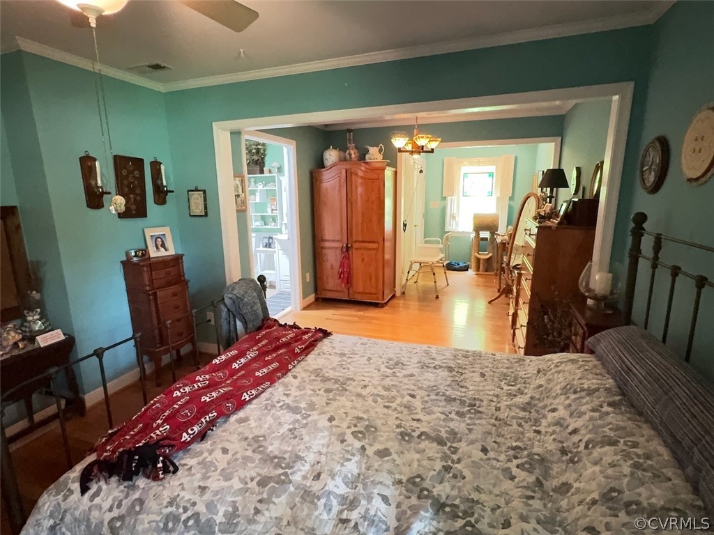 12001 Sunset Drive Ashland, VA 23005 - Photo 16 of 40 a bedroom with a large bed a flat tv screen and dresser