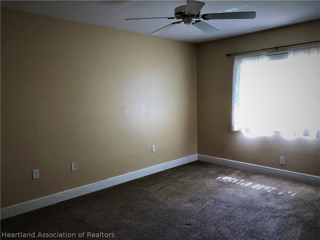 4440 Mandarin Road Sebring, FL 33875 - Photo 11 of 17 an empty room with a ceiling fan and window