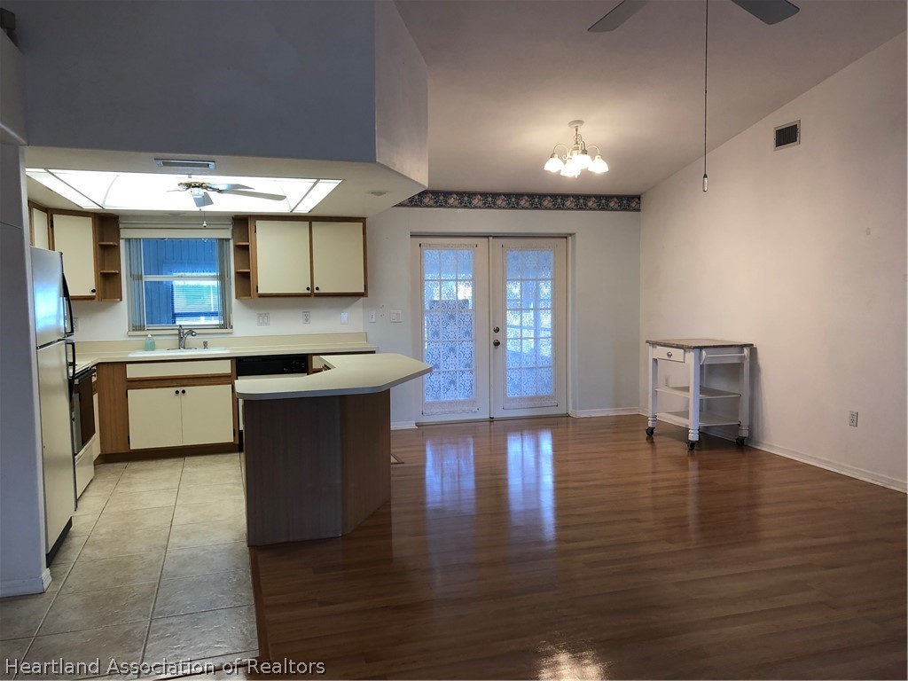 4440 Mandarin Road Sebring, FL 33875 - Photo 12 of 17 a kitchen with a stove cabinets and wooden floor