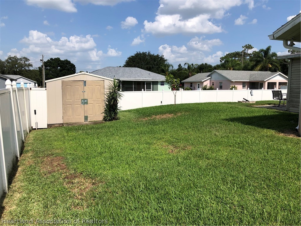 4440 Mandarin Road Sebring, FL 33875 - Photo 13 of 17 a view of a house with a yard