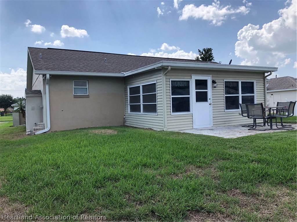 4440 Mandarin Road Sebring, FL 33875 - Photo 15 of 17 a front view of a house with a garden and yard