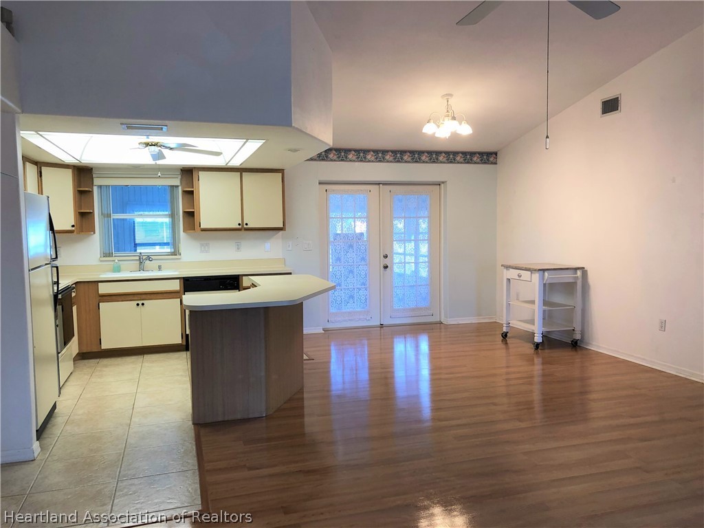 4440 Mandarin Road Sebring, FL 33875 - Photo 3 of 17 a kitchen with a sink cabinets and wooden floor