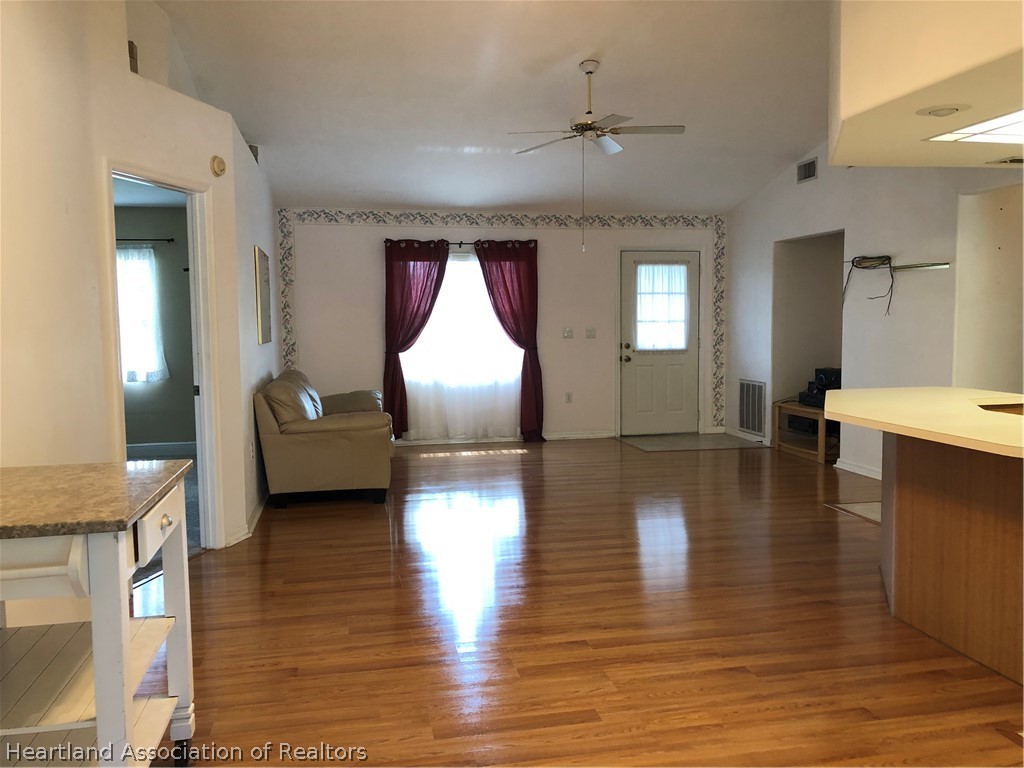 4440 Mandarin Road Sebring, FL 33875 - Photo 4 of 17 a view of a livingroom with furniture wooden floor and a kitchen