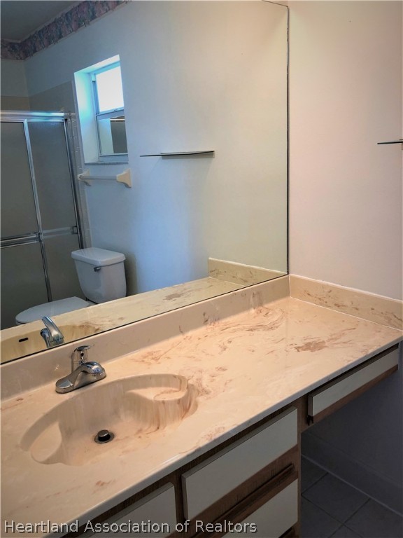 4440 Mandarin Road Sebring, FL 33875 - Photo 8 of 17 a bathroom with a sink and a mirror