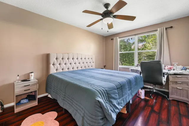 a bedroom with a bed and a desk