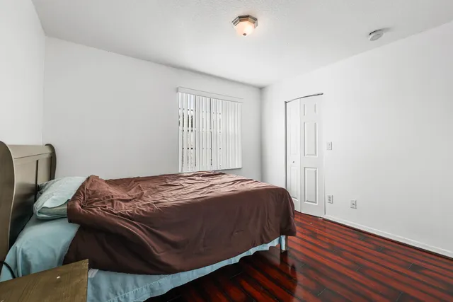 a bed sitting in a bedroom next to a window