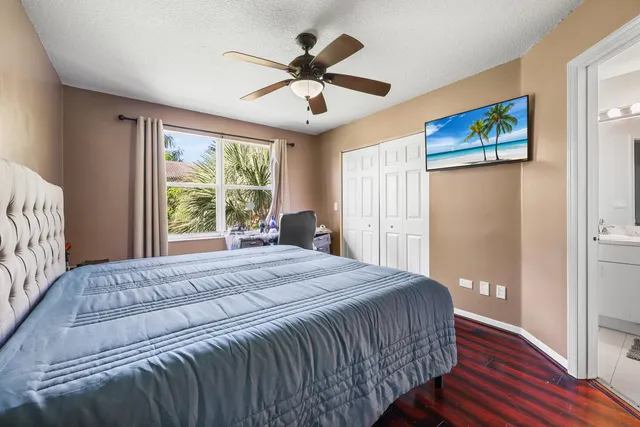 a bedroom with a large bed and a large window