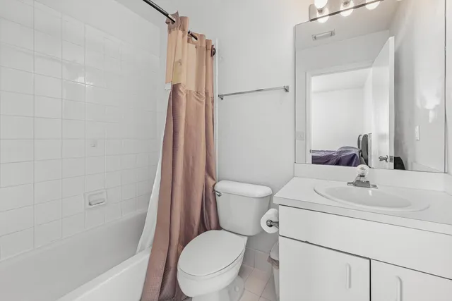 a white toilet sitting next to a bath tub