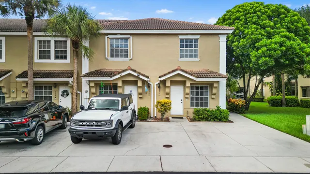 a couple of cars parked in front of a house