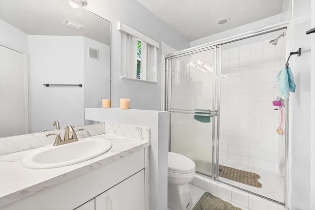 a bathroom with a sink toilet and shower