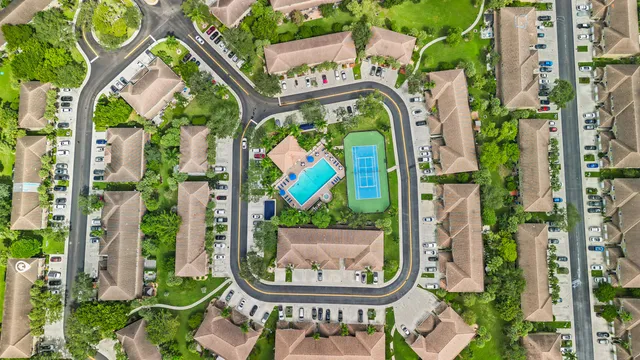 an aerial view of a house with garden space and street view