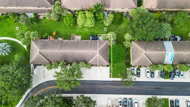 an aerial view of a house with a yard and a fountain