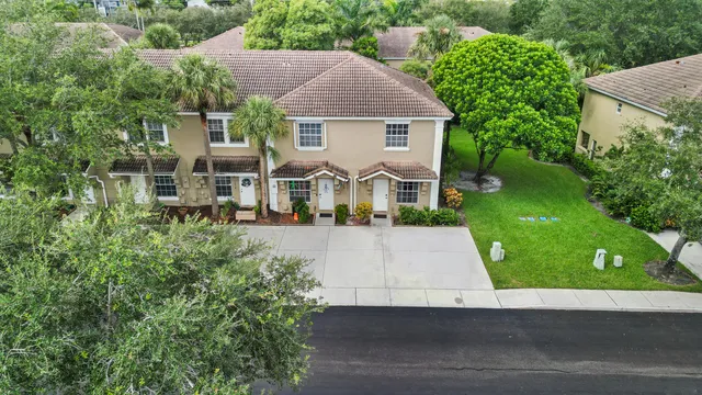 an aerial view of a house with a yard