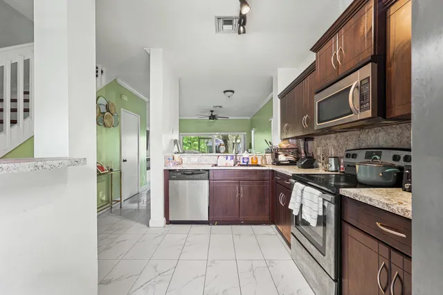 a kitchen with stainless steel appliances granite countertop a sink and cabinets