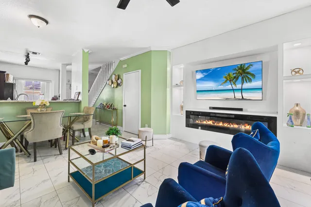 a living room with furniture a rug and a painting