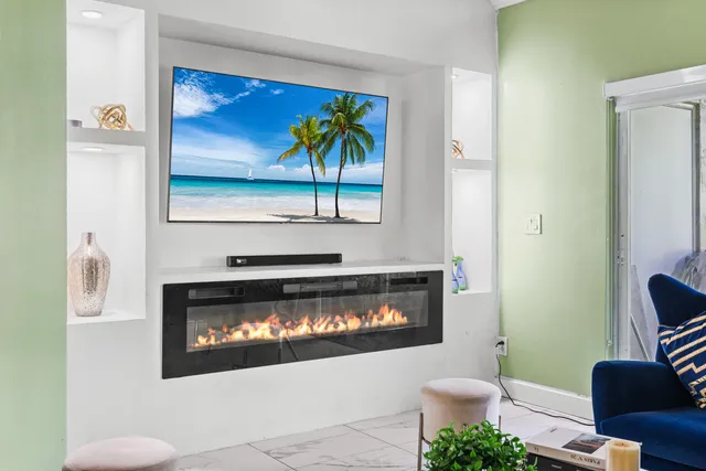 a living room with furniture a fireplace and a flat screen tv