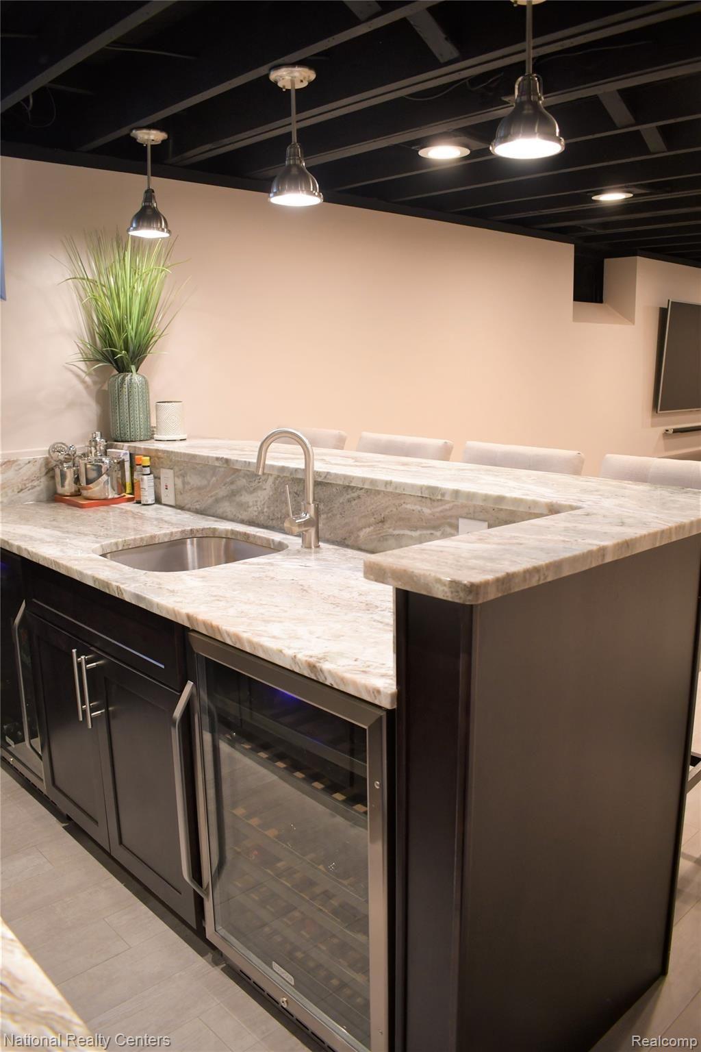 4112 Wakefield Road Berkley, MI 48072 - Photo 28 of 42 Lower Leval features custom built bar with quartzite counters, espresso shaker cabinets and two beverage refrigerators!
