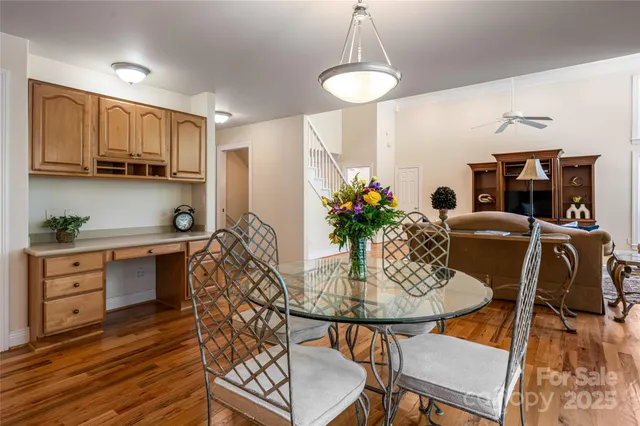 a kitchen with stainless steel appliances kitchen island granite countertop a table and chairs in it