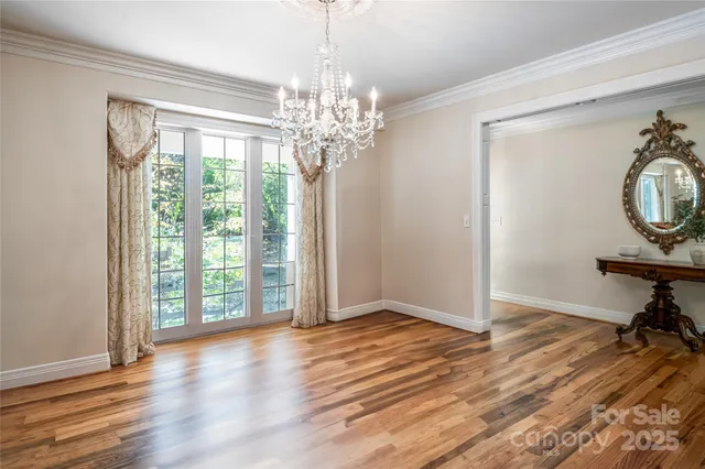 a view of a room with wooden floor and a window