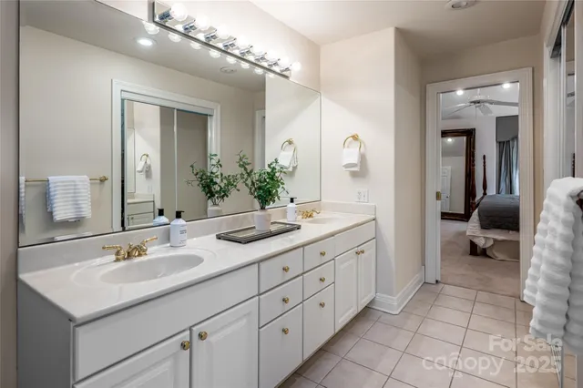 a spacious bathroom with a granite countertop sink a mirror and a