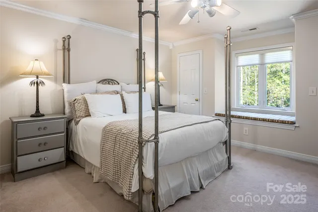 a bedroom with a bed and a night stand next to a window