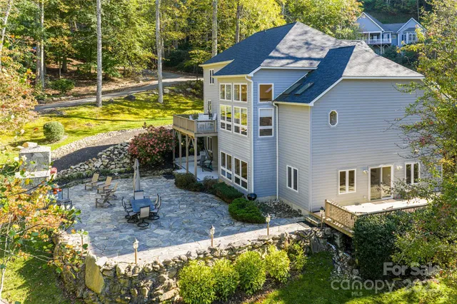 a aerial view of a house with a yard table and chairs
