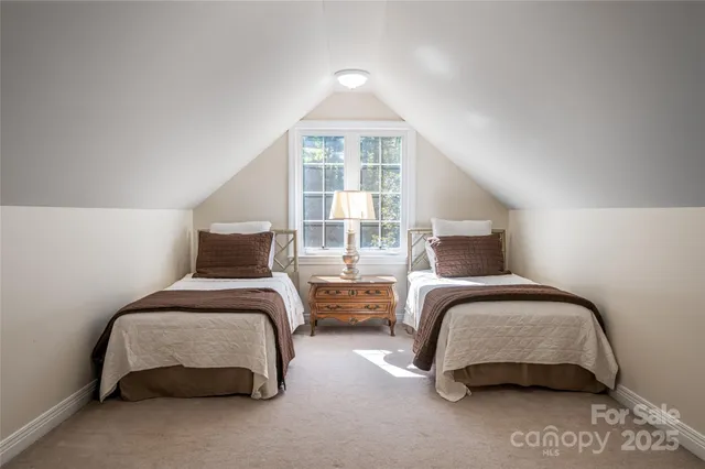 a bedroom with two beds and a window