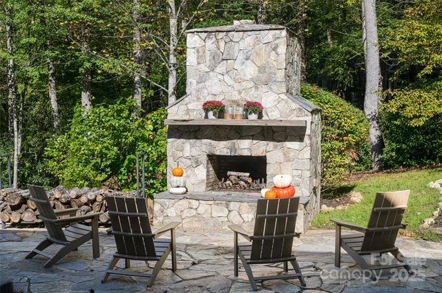 a view of a chairs and table in backyard