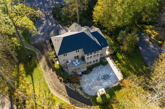 a view of a wooden house with a yard
