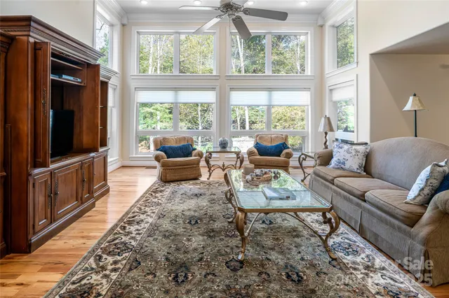 a living room with furniture tv and a large window
