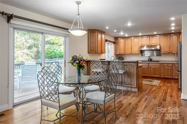 a dining room filled chandelier and wooden floor