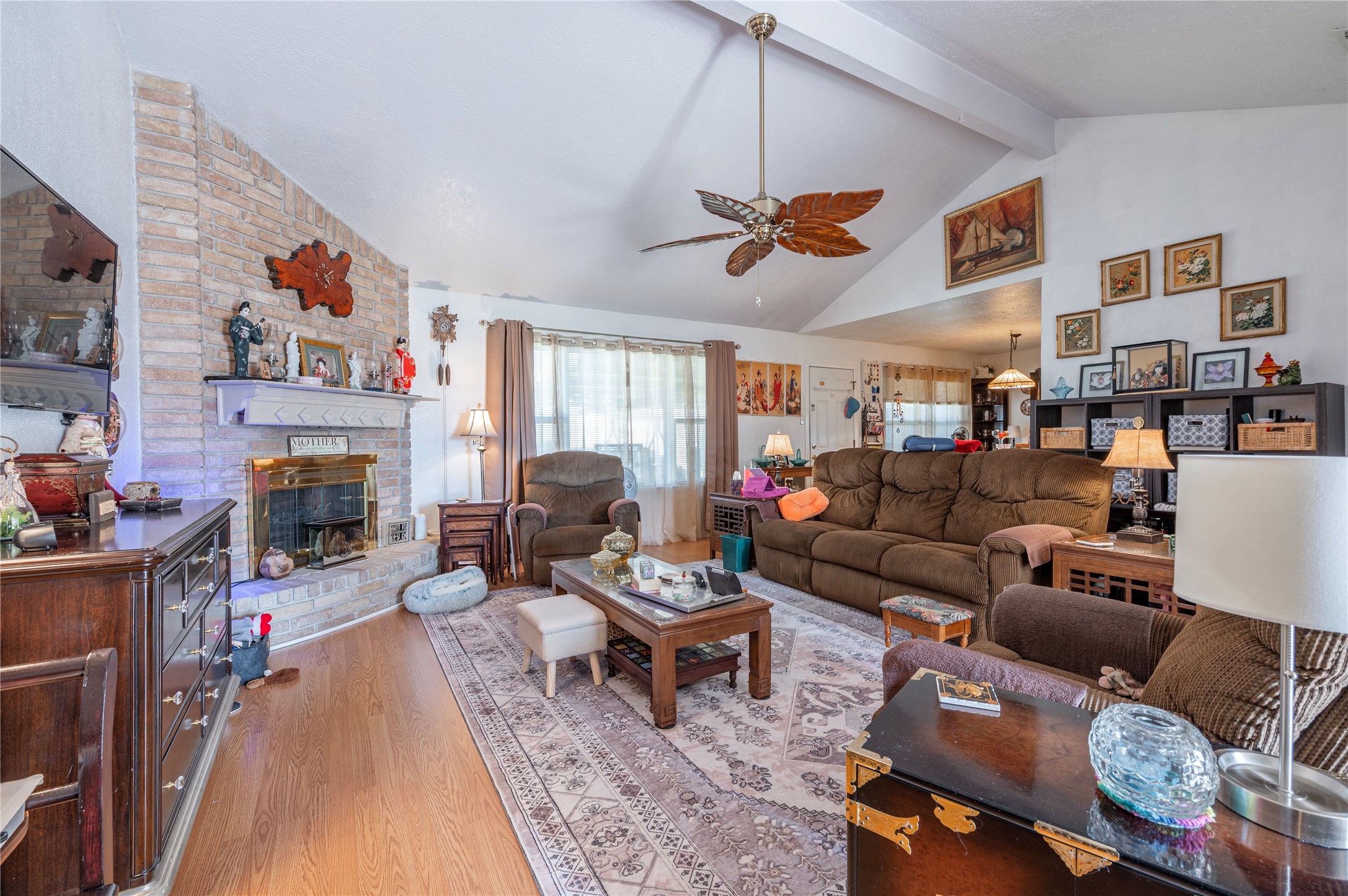 10107 Rocky Hollow Road La Porte, TX 77571 - Photo 6 of 33 a living room with furniture a fireplace and a ceiling fan