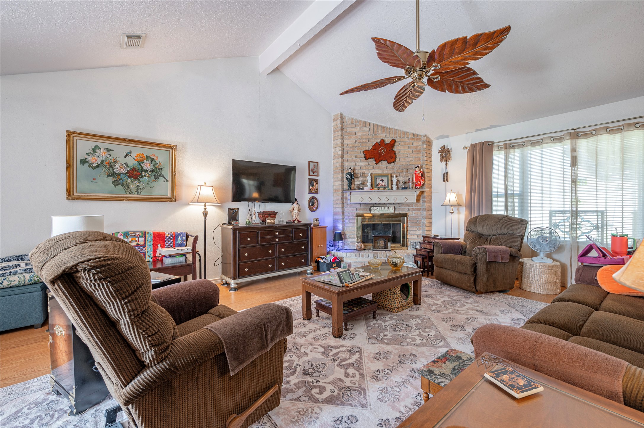 10107 Rocky Hollow Road La Porte, TX 77571 - Photo 7 of 33 a living room with furniture a flat screen tv and a fireplace