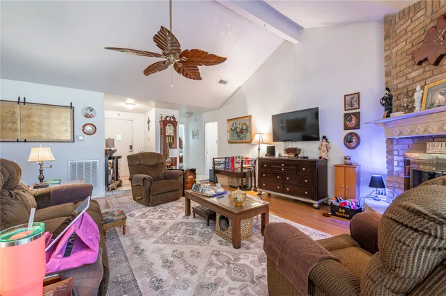 a living room with furniture a flat screen tv and a window