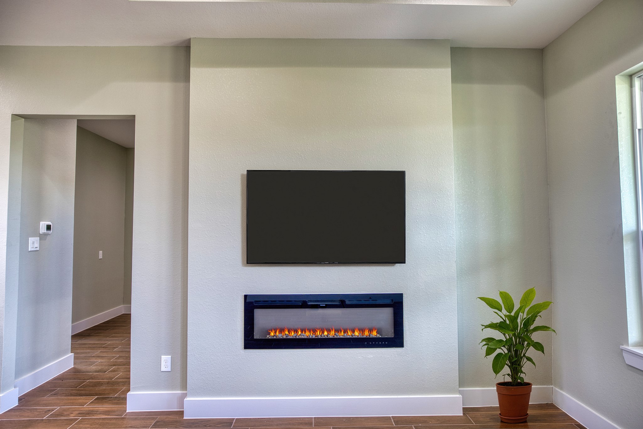 925 Buffalo Trail Angleton, TX 77515 - Photo 14 of 45 a living room with a fireplace and potted plant