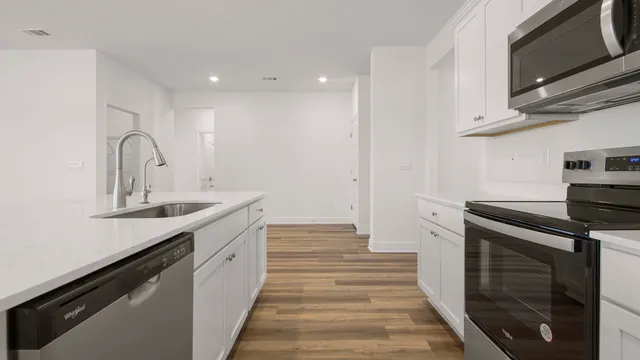 a kitchen with a sink and a refrigerator