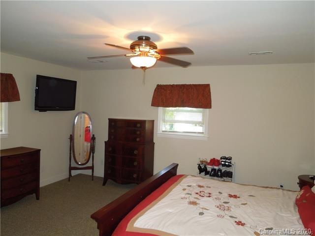 5531 Hickory Grove Road Charlotte, NC 28215 - Photo 11 of 24 a bedroom with a bed and a television