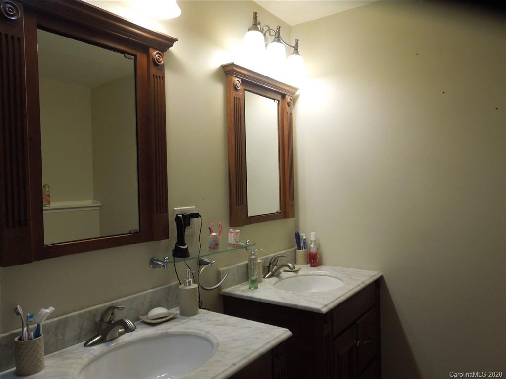 5531 Hickory Grove Road Charlotte, NC 28215 - Photo 13 of 24 a bathroom with a sink vanity and a mirror