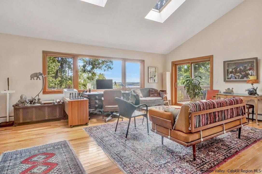 71 Carly Road Woodstock, NY 12498 - Photo 20 of 34 a living room with furniture a large window and a table