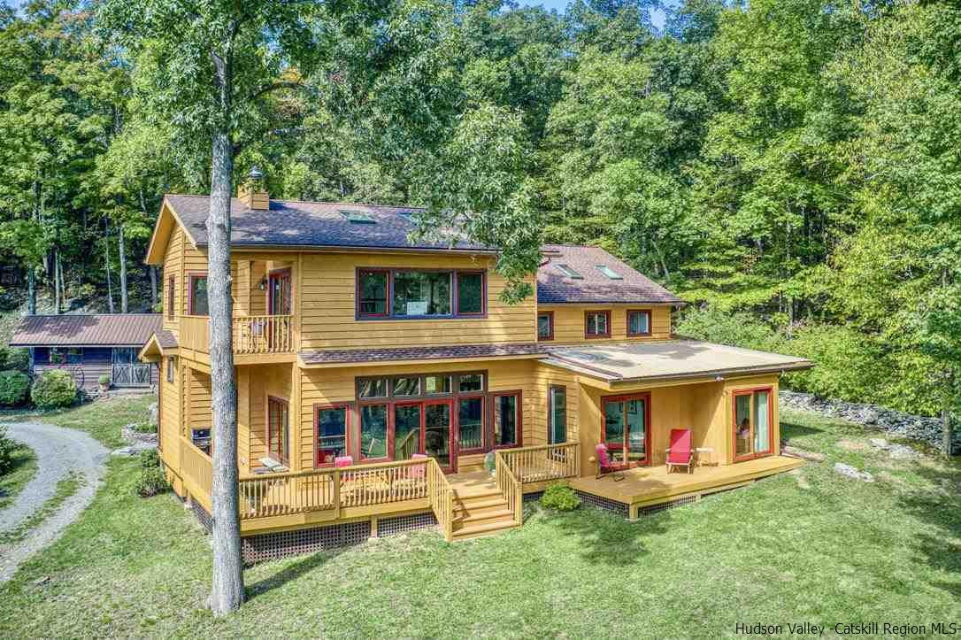 71 Carly Road Woodstock, NY 12498 - Photo 30 of 34 a front view of a house with a yard table and chairs