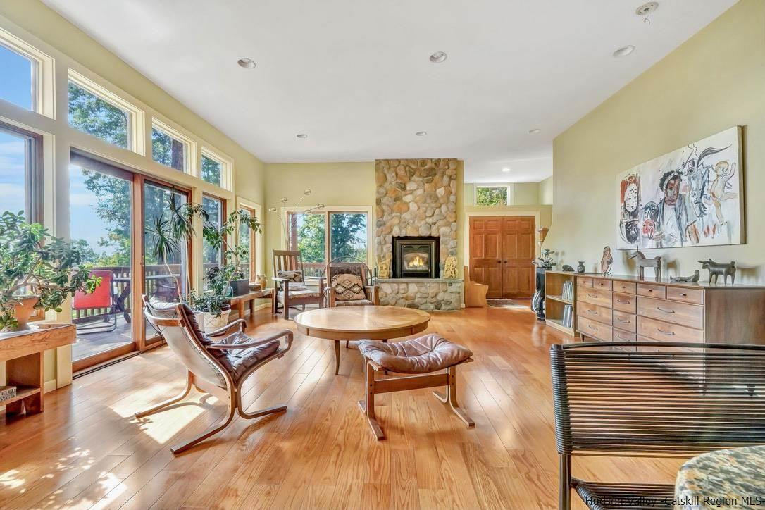 71 Carly Road Woodstock, NY 12498 - Photo 3 of 34 a living room with fireplace furniture and a floor to ceiling window