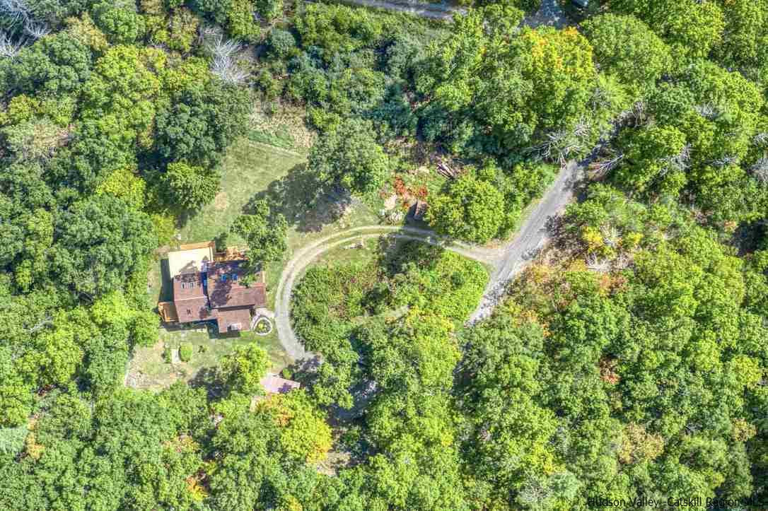 71 Carly Road Woodstock, NY 12498 - Photo 34 of 34 a backyard of a house with lots of green space and garden
